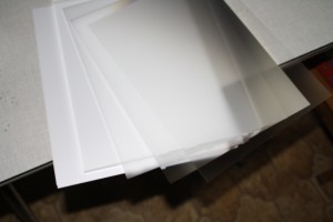 Diffuser with some other plastic films on top of a plastic panel and a white paper